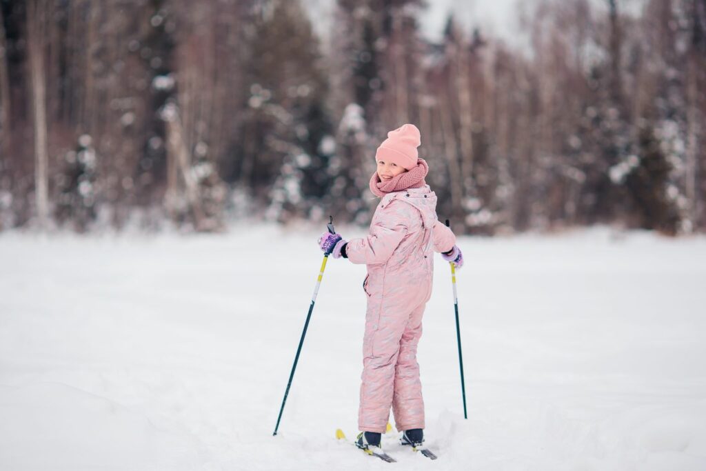 Little girl skiing in the mountains. Winter sport for kids.